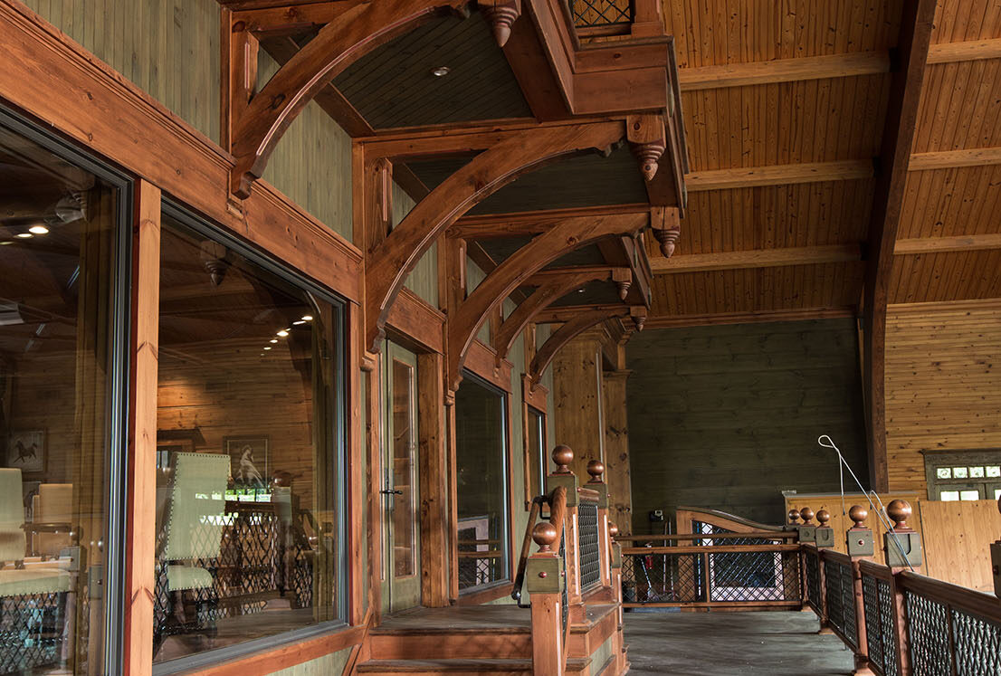 patio section separating the equine facility interior with its exterior sitting beneath a wooden ceiling