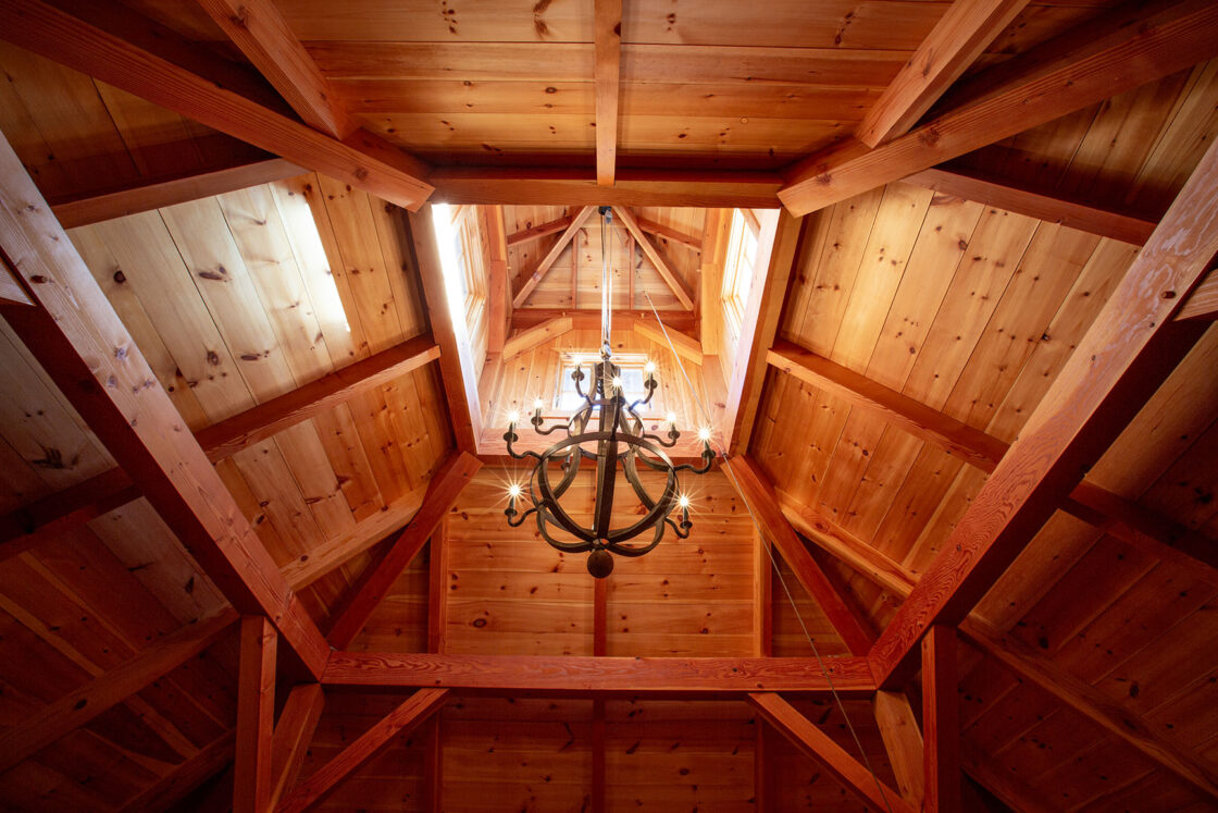 custom garage interior with a hanging light fixture illuminated and providing light in the middle of the room