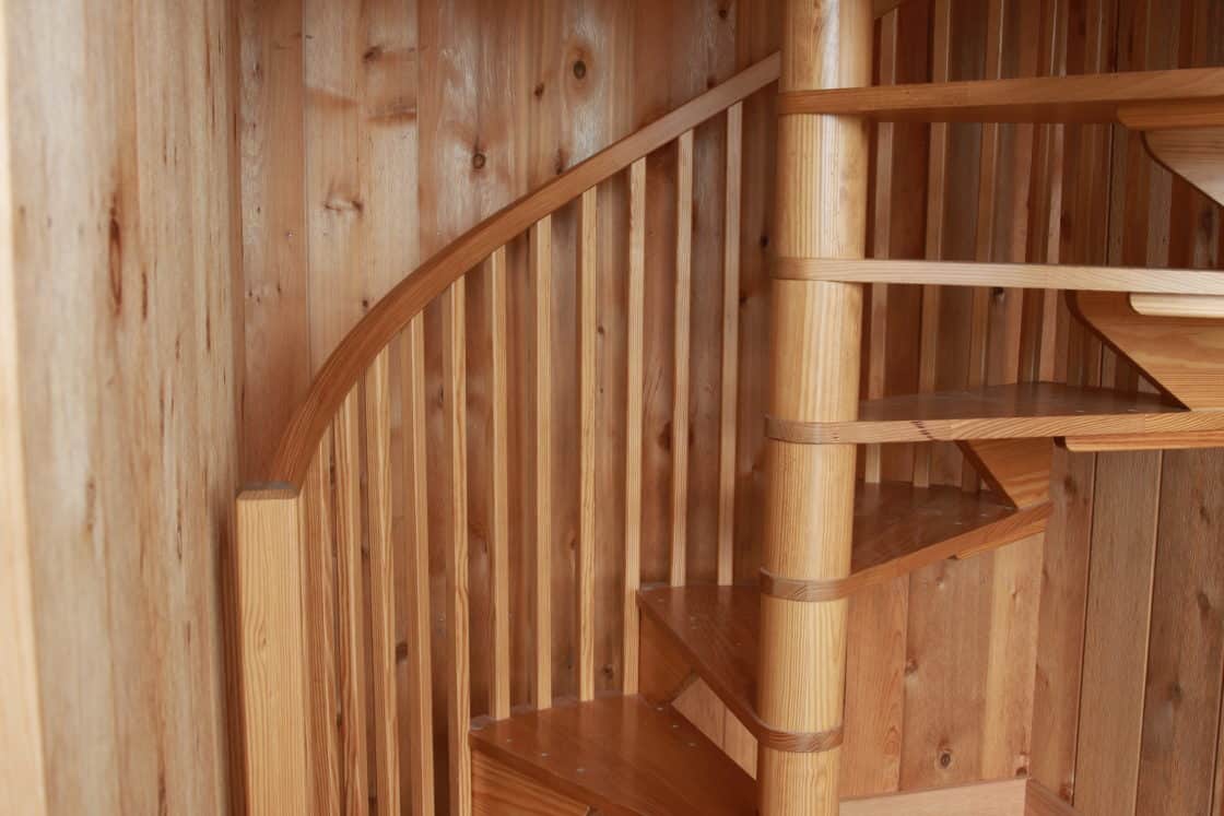 wooden circular staircase connect first and second floors of garage