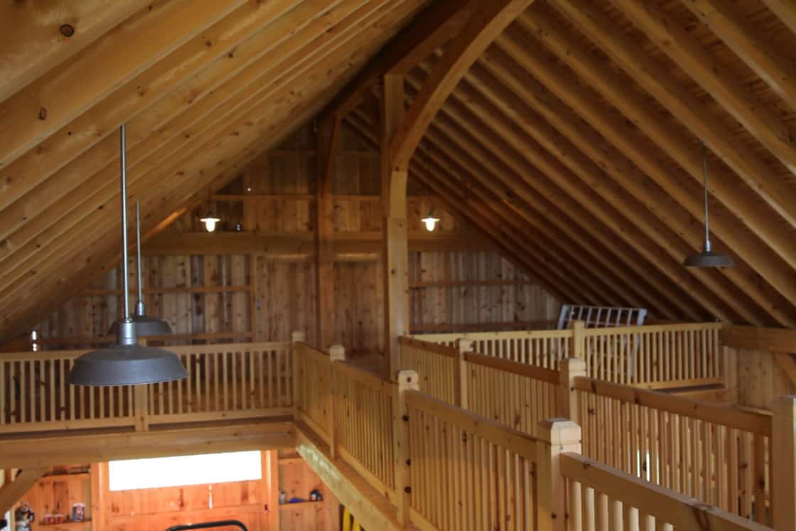 second story view of custom garage overlooking tractor parked inside
