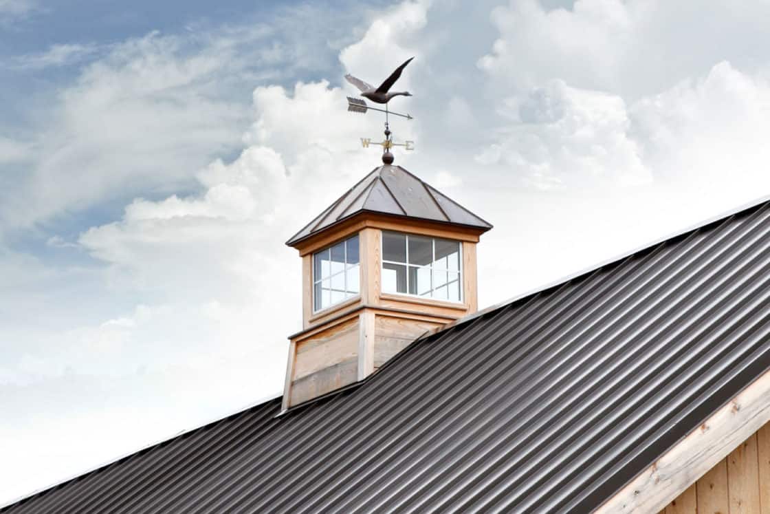ornate cupola sitting on metal roof of custom garage