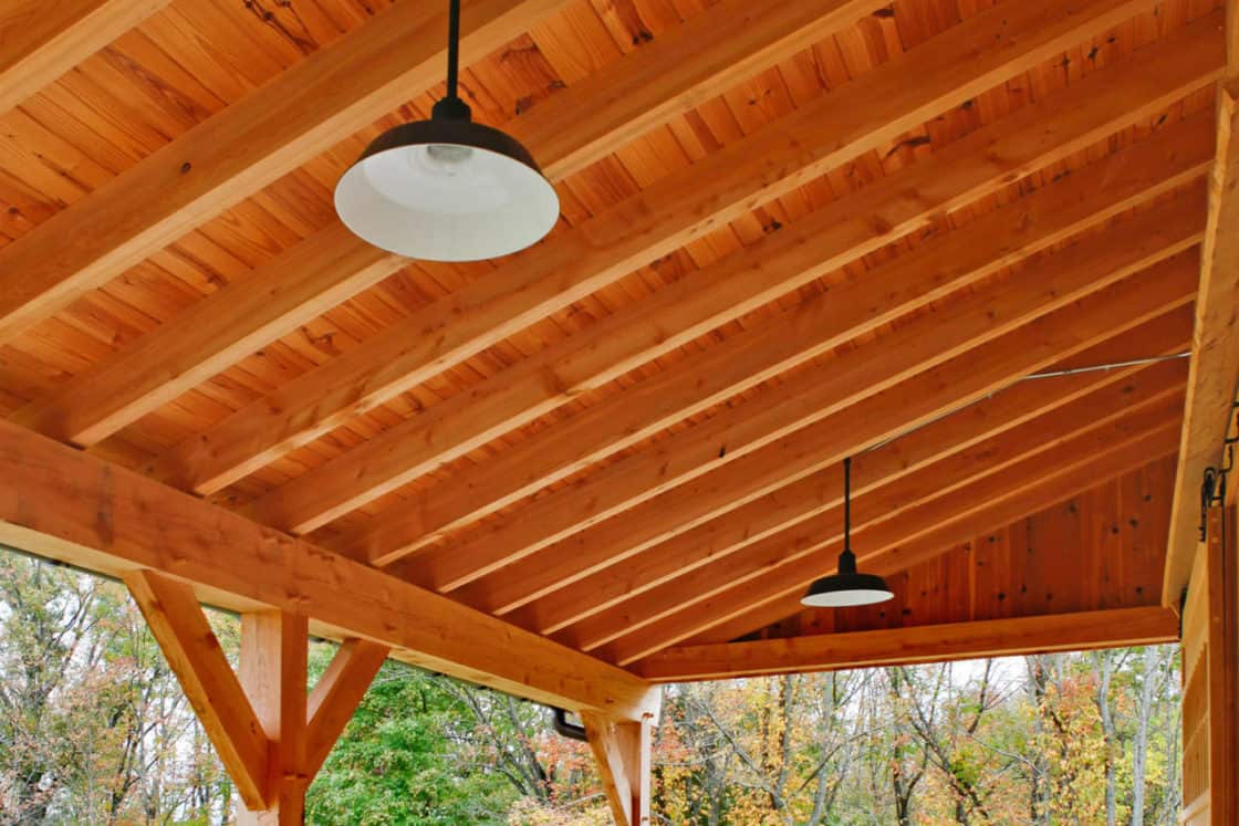 interior view of porch overhang roof with wooden bench