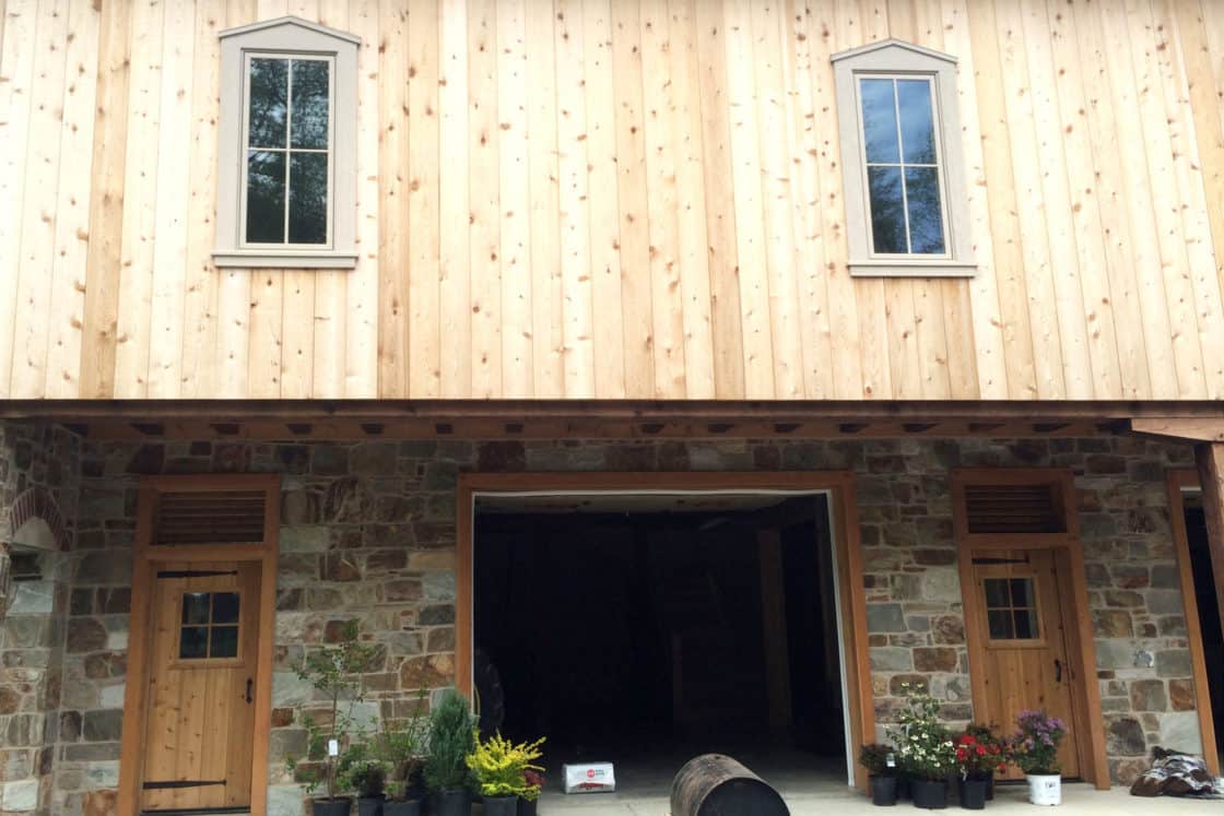 wooden bank barn first floor entryway and second story windows