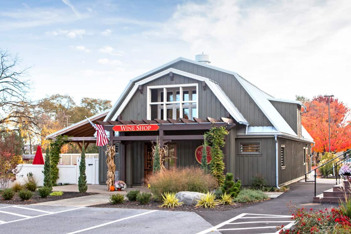 wine shop store front sitting behind blacktop and beneath blue sky
