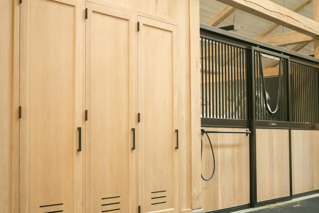 newly built wooden horse stables inside equestrian facility in greenwich ct