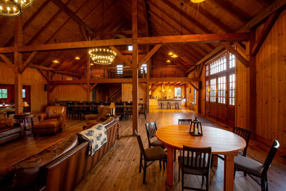 living room of party barn with hardwood floor and ornate furniture sitting throughout