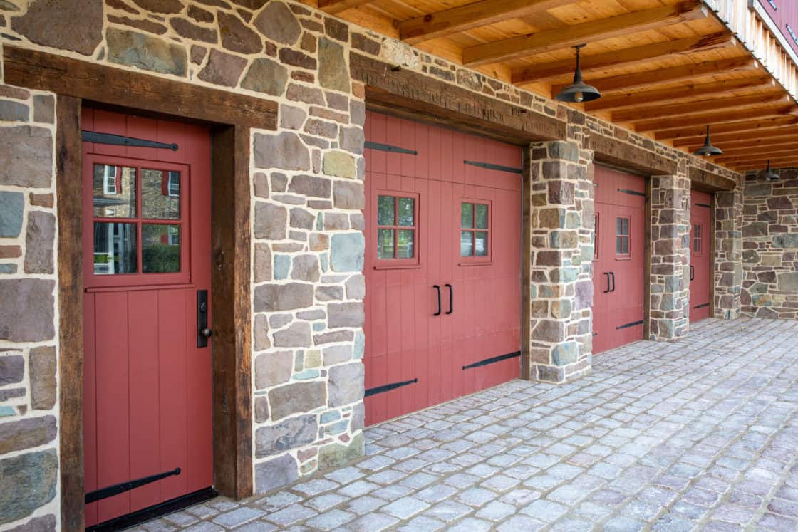 red wooden party barn doors surrounded by stone siding and concrete flooring