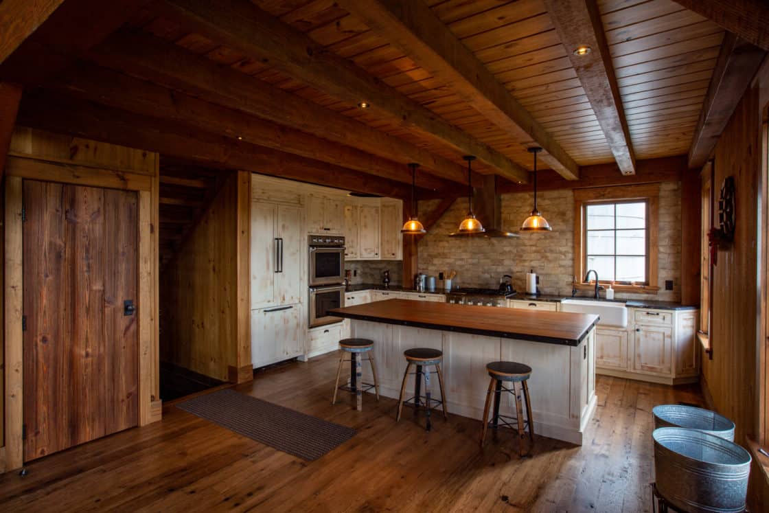 vintage style kitchen with island and stools inside of party barn