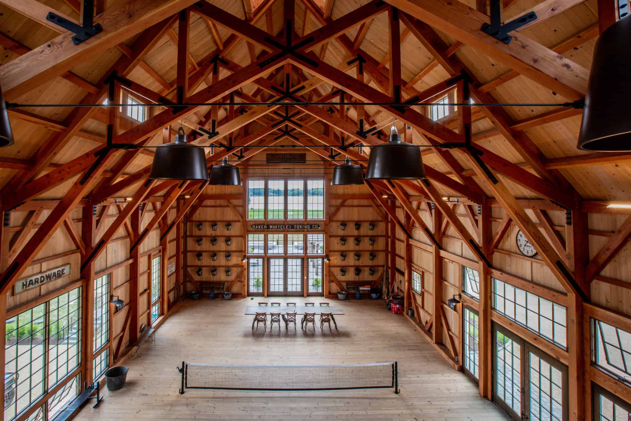 elevated view of newly built party barn with large windows and symmetrical ceiling beams