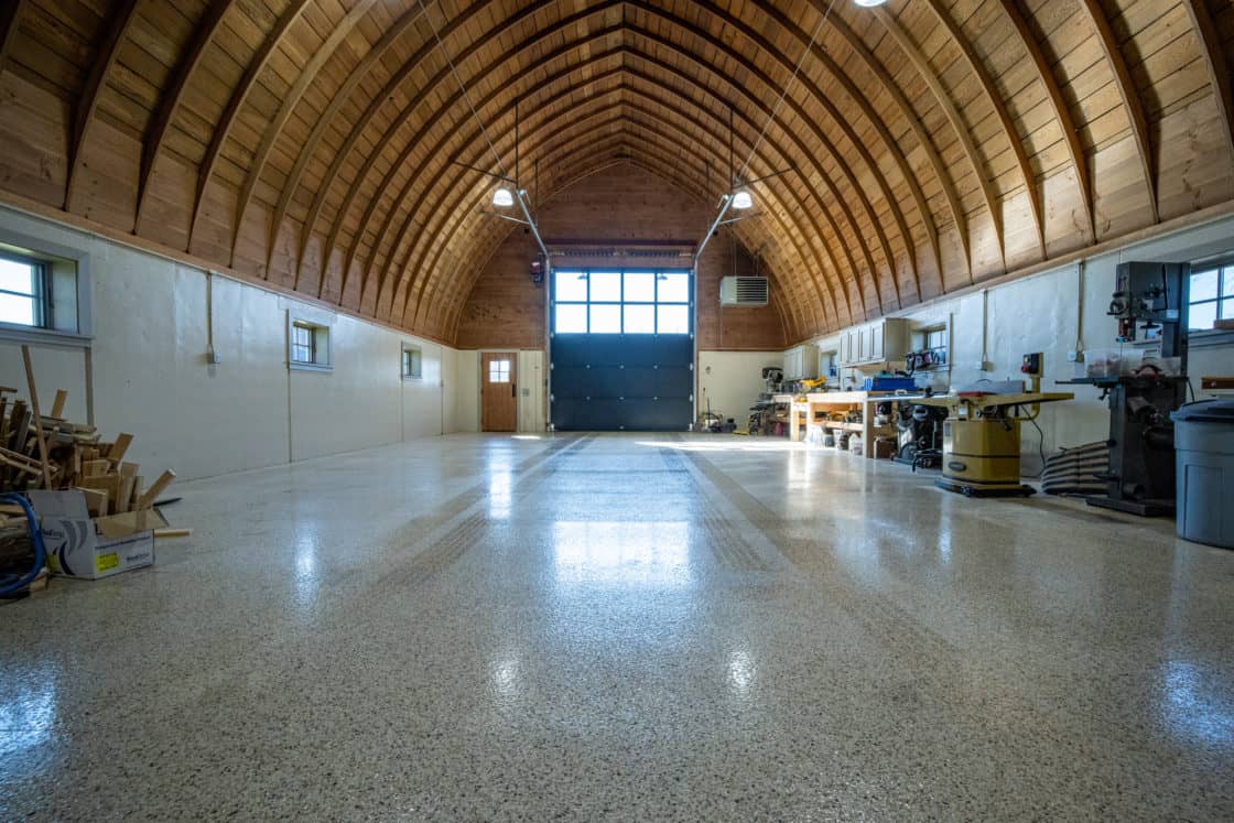 interior of custom garage with finished floor and symmetrical ceiling panels