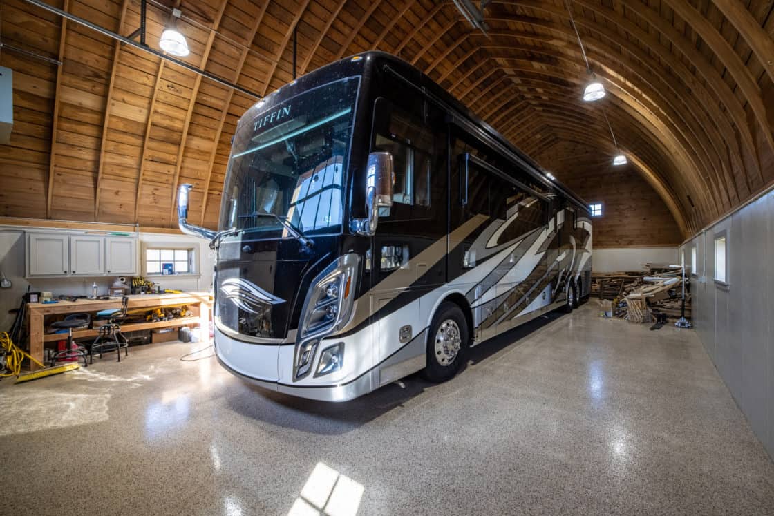 rv parked inside custom built garage sitting on finished floor