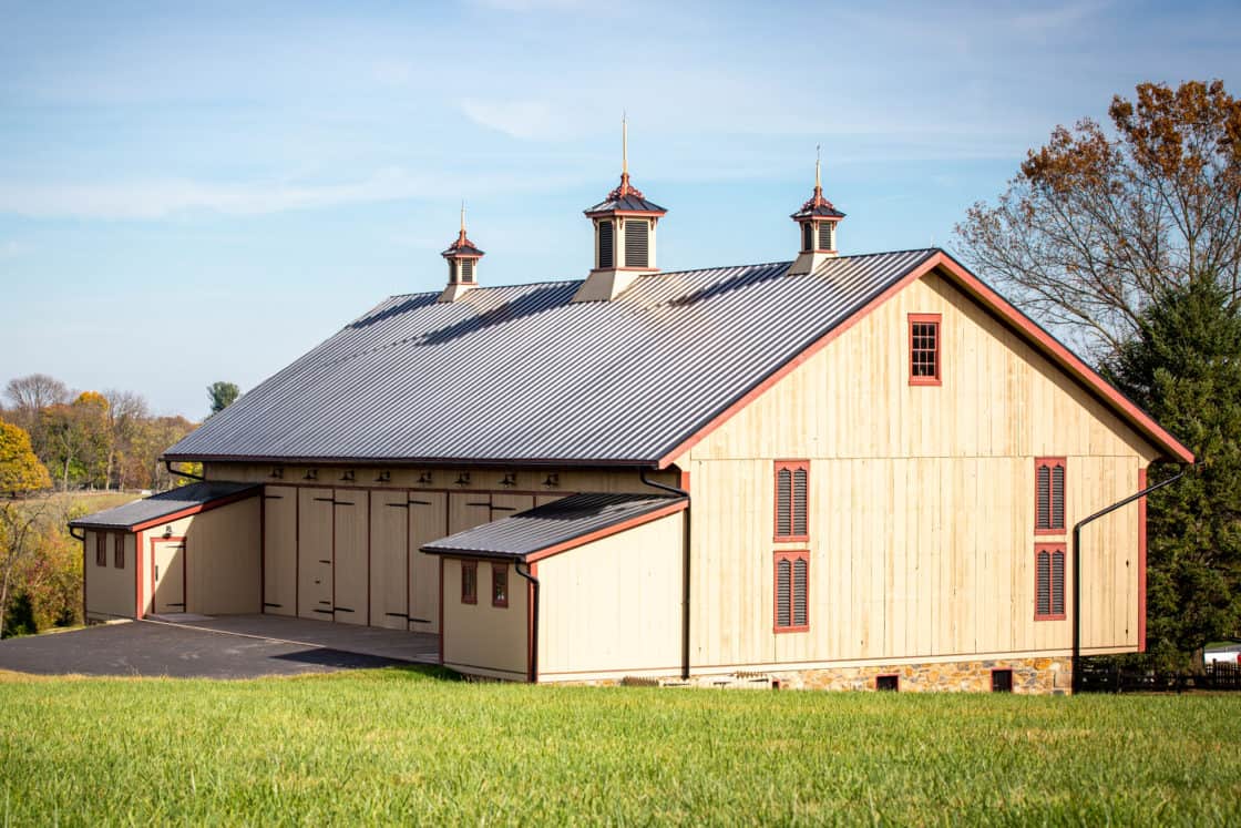 rear view of recently restored barn with new cupolas and original wood siding