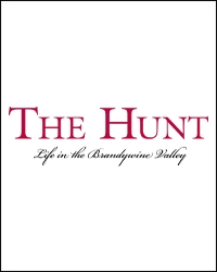 Logo with the words The Hunt in large red capital letters, and Life in the Brandywine Valley in black cursive script below—perfect for those seeking a luxury home or dreaming of a party barn, all centered on a crisp white background.
