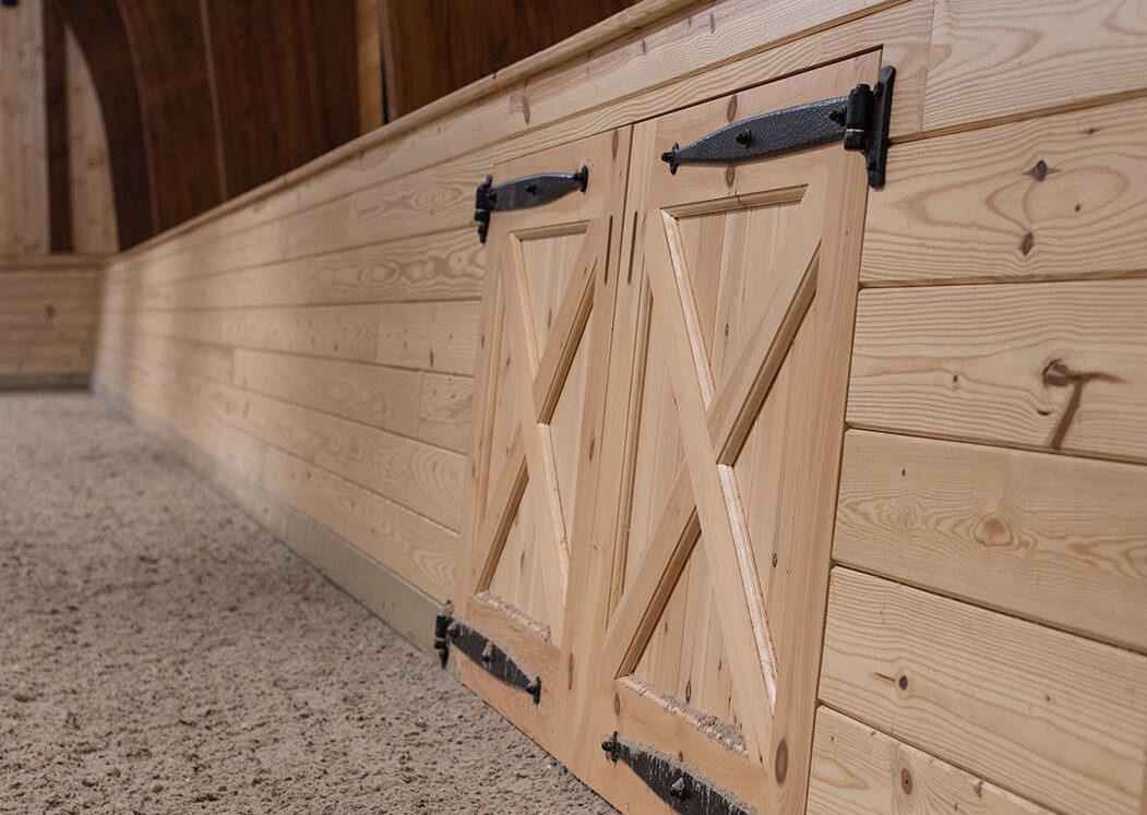 wooden wall with symmetrical doors sitting against the riding surface