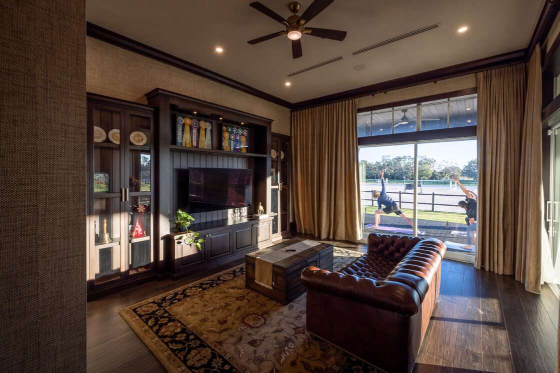 interior recreational space with a television set along with a leather couch and small coffee table