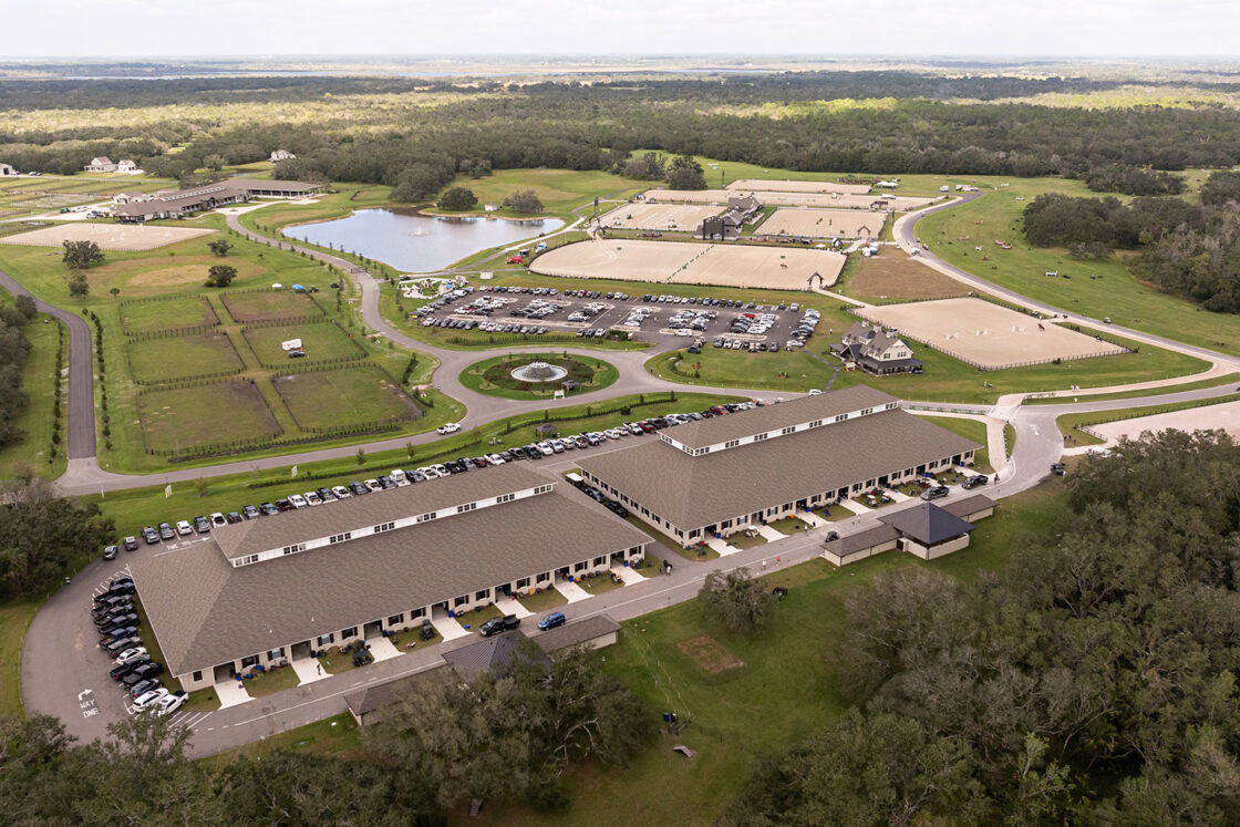 drone view of the terra nova equestrian center with various riding sections visible and two stables in the bottom left and middle as well