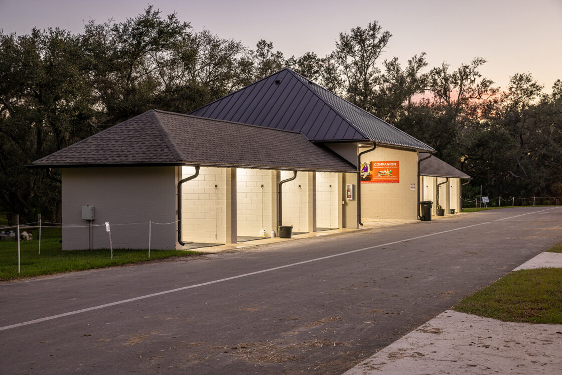 custom built washing stalls with a metal roof covering the middle section and a shingled roofs covering the two adjacent sides