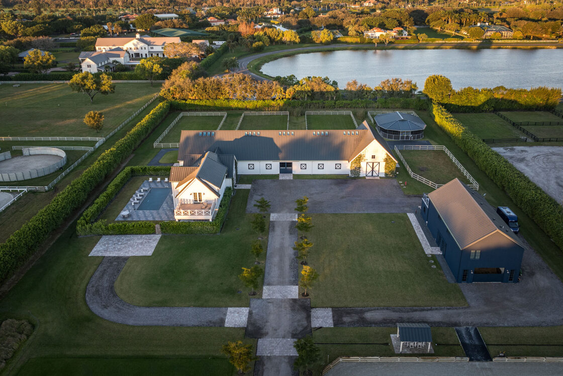 An aerial view of a large house with a swimming pool