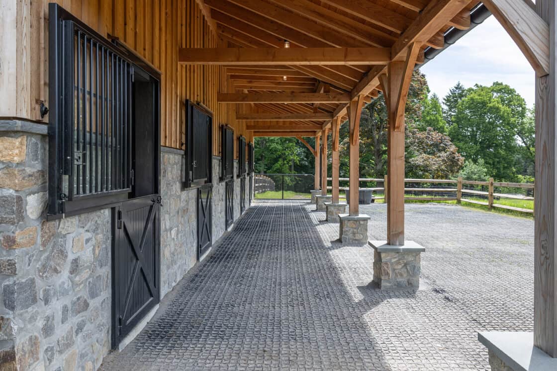 horse barn stall windows descending outward with a wooden overhang above them