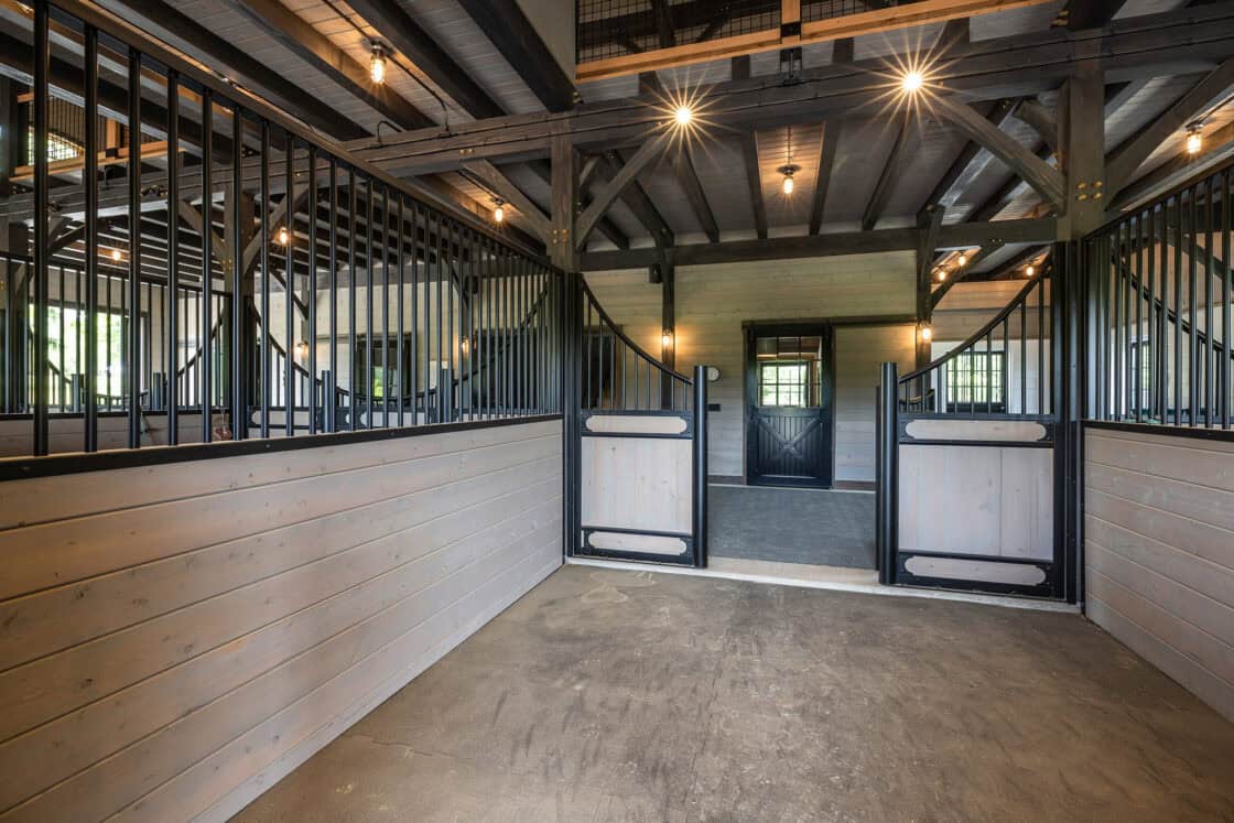 custom horse stall sitting inside luxury barn