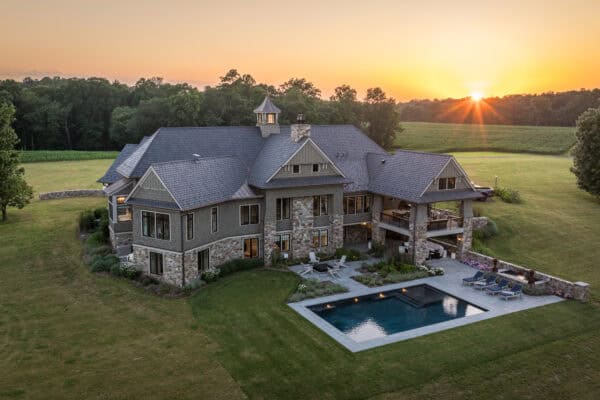 luxury custom estate sitting amidst sunrise background