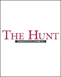 White background with large red text in the center reading “THE HUNT.” Below, a small black banner features white text: “THE BRANDYWINE VALLEY HOME INDEX,” inspired by luxury homes and iconic bank barns.